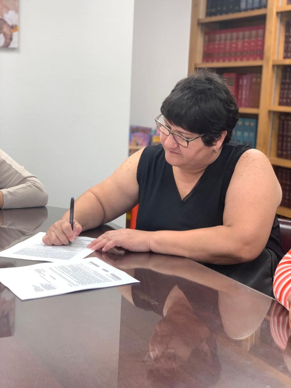 A client signing closing documents on their Central Florida home purchase